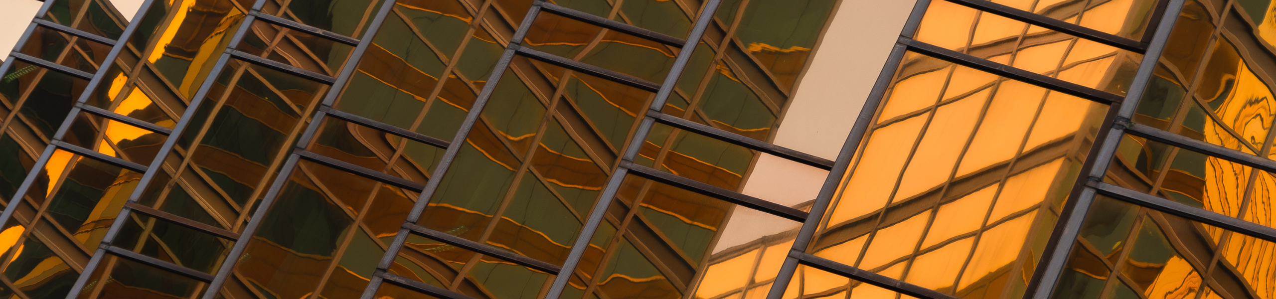 golden building. windows glass of modern office skyscrapers in technology and business concept. facade design. construction structure of architecture exterior for urban cityscape background.